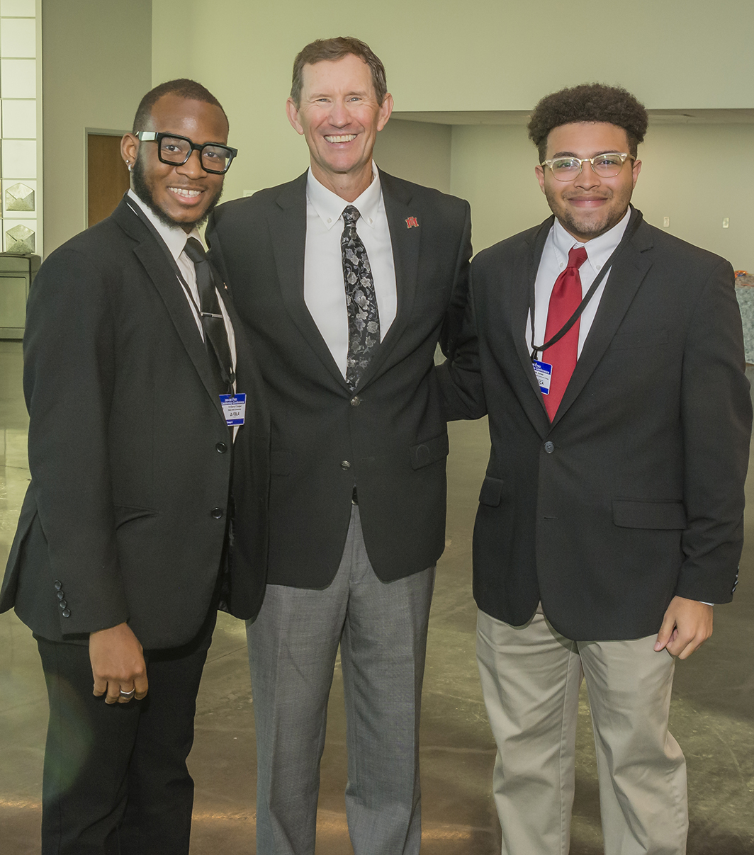 MS Collegiate Student Organization's FBLA and DECA Presidents take a picture with East MS Community College President, Dr. Scott Alsobrooks at the East MS Community College Communiversity durning the 2024 FLC.